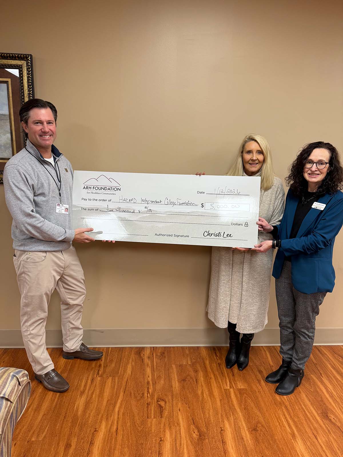 people holding a giant check