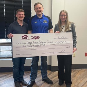 people holding a big check