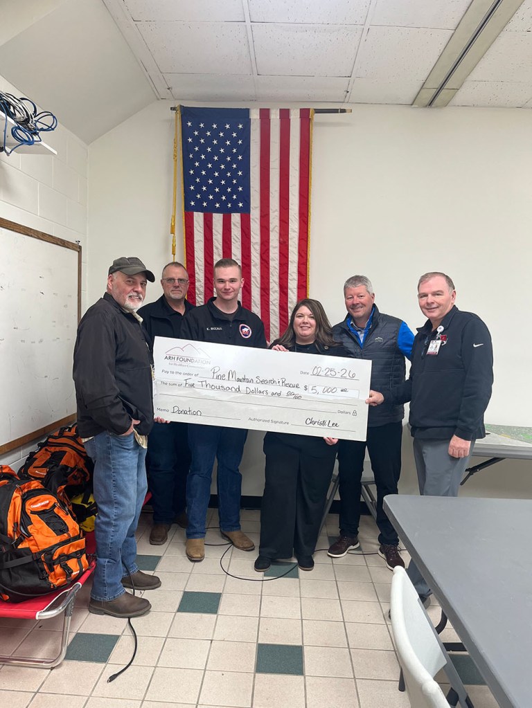 People holding a large check