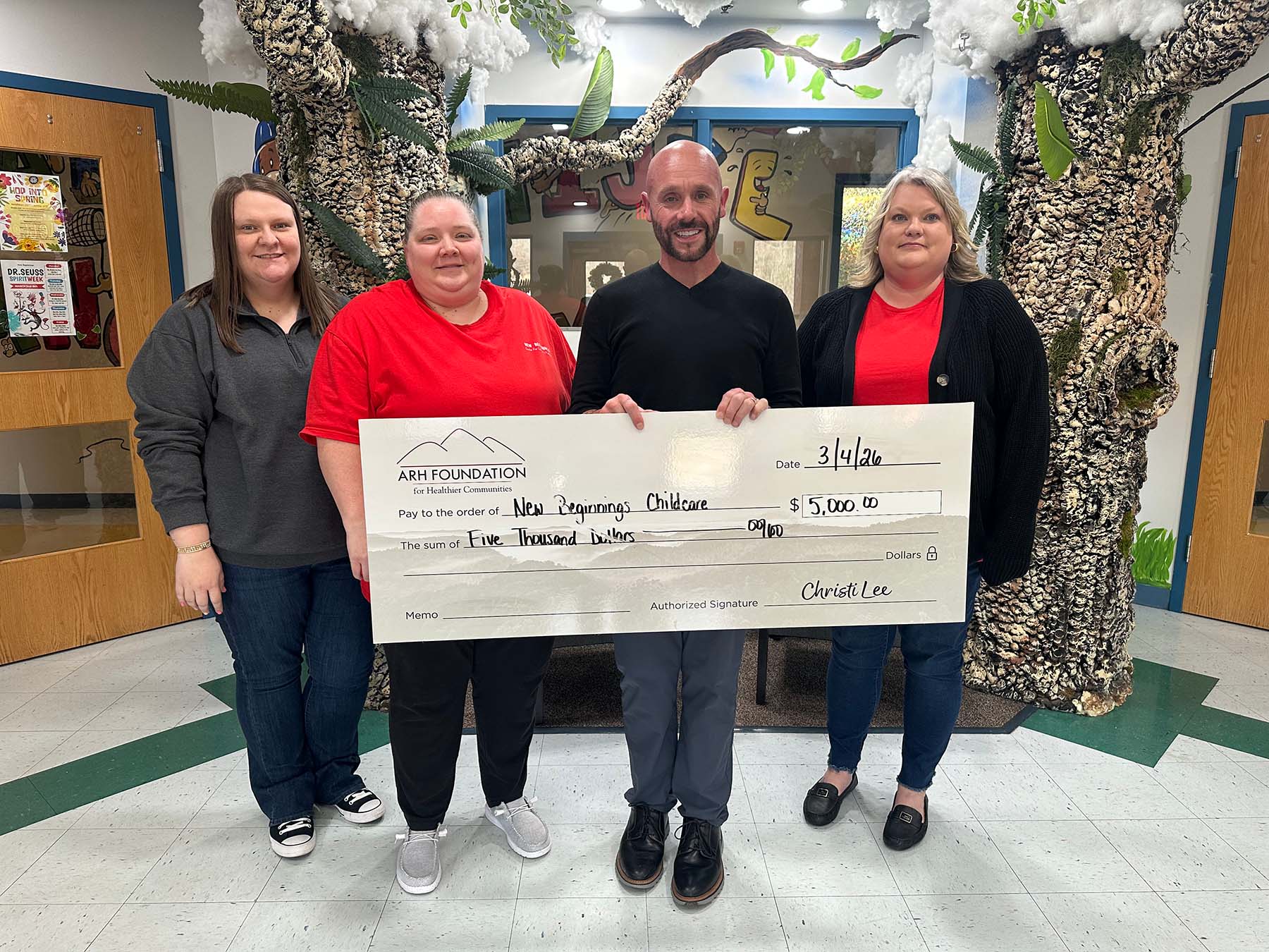 People holding a large donation check