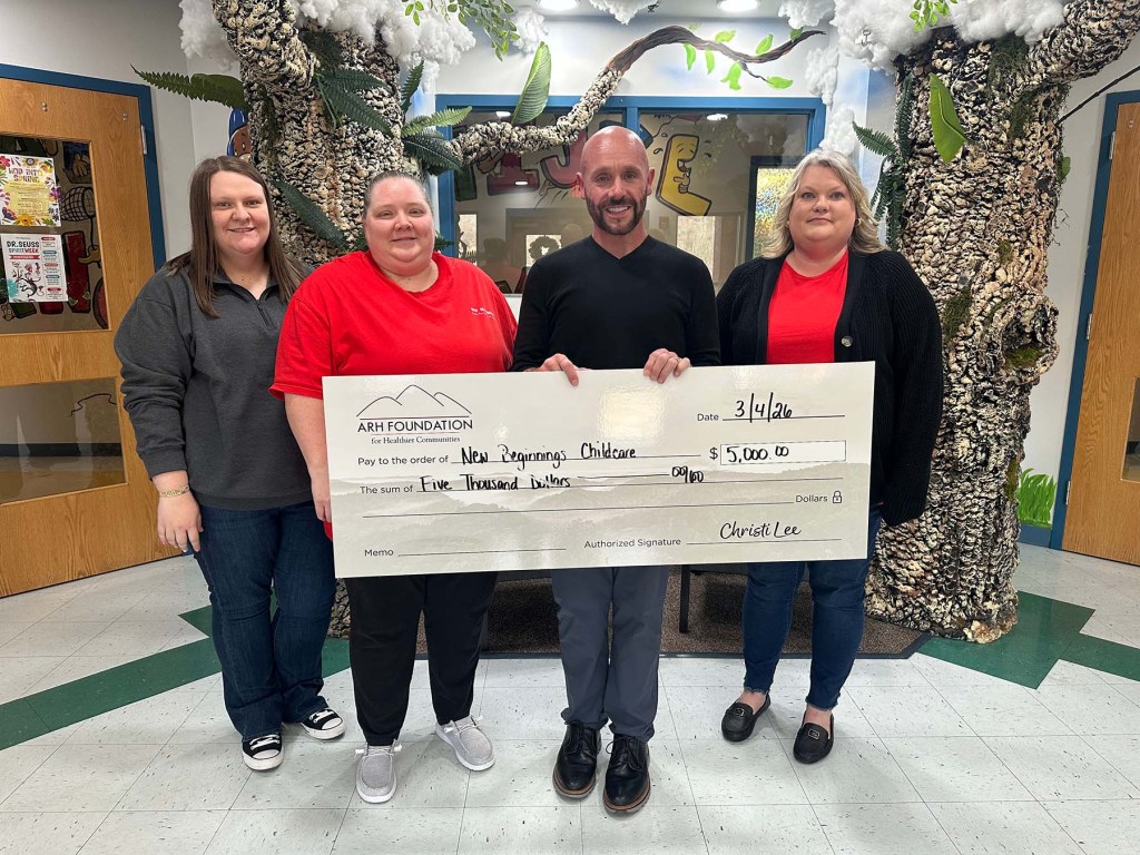 People holding a large donation check